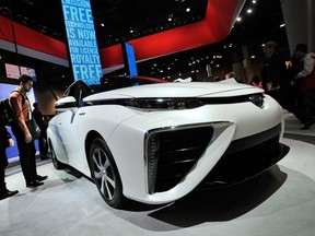 Attendees looks at the Toyota Mirai fuel-cell automobile while it is displayed at the Toyota booth at the 2015 International CES at the Las Vegas Convention Center on January 6, 2015 in Las Vegas, Nevada. CES, the world's largest annual consumer technology trade show, runs through January 9.