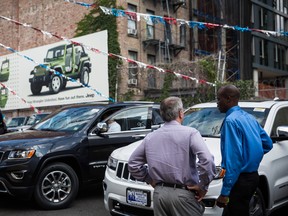 In this file photo, Kelly Brown (R) helps Saul Scherl shop for a Jeep at a car dealership on August 6, 2014 in New York City.