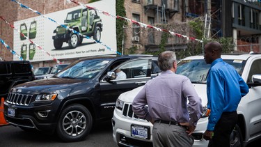 In this file photo, Kelly Brown (R) helps Saul Scherl shop for a Jeep at a car dealership on August 6, 2014 in New York City.