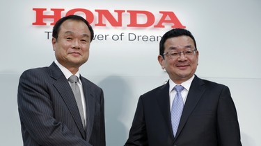 Honda's newly appointed president Takahiro Hachigo, right, shakes hands with Takanobu Ito during a press conference at the automaker's headquarters. in Tokyo, Monday, Feb. 23, 2015. The Japanese automaker at the center of an air-bag defect scandal, said Monday its president Ito will step aside and be replaced by Honda executive Hachigo.