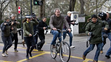 Jeremy Clarkson is surrounded by media personnel as he leaves his home on a bicycle in London on March 26, 2015. Oisin Tymon, the producer involved in the "fracas", stated he won't be pressing charges against Clarkson.