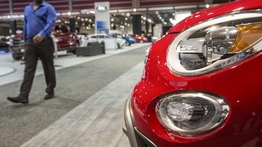 A man browses the FIAT section the 2015 International Auto and Truck Show at the BMO Centre in Calgary, on March 10, 2015.