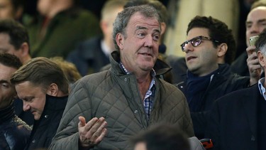 TV host Jeremy Clarkson gestures as he takes his place in the stands before the Champions League round of 16 second leg soccer match between Chelsea and Paris Saint Germain at Stamford Bridge stadium in London, Wednesday, March 11, 2015.