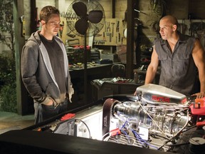 Paul Walker, left, and Vin Diesel, are shown in a scene from Fast & Furious 7.