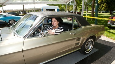 Laura Ballance behind the wheel of her classic Ford Mustang.