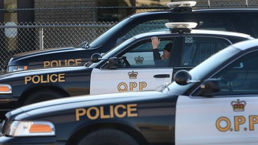 An Ontario Provincial Police officer sits in his cruiser Wednesday, Dec. 12, 2012, at the Tecumseh, Ont. detachment. New OPP data reveals young males between 25-34 years of age are most likely to die in a collision on the road.