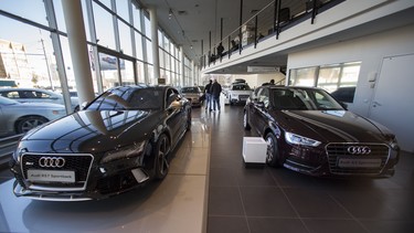 Russian customers walk between cars on a display at an Audi dealership in Moscow, Russia. Russian car sales dropped 37.9 per cent year-on-year in February.