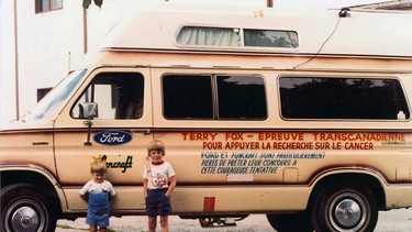 Two unknown young boys stand in front of the Terry Fox Marathon of Hope