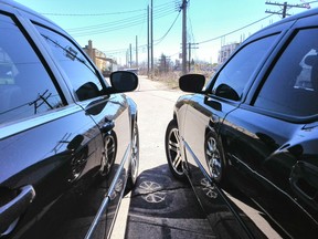A 2009 Chrysler 300 on the left and 2006 Dodge Charger R/T on the right with tinted windows.