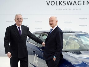 A photo taken on April 23, 2012, shows Volkswagen CEO Martin Winterkorn, left, and Chairman of the supervisory board of Volkswagen Ferdinand Piech posing in front of an Audi A3 electric car during a signing ceremony and a visit to the Volkswagen plant in Wolfsburg.