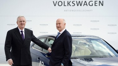 A photo taken on April 23, 2012, shows Volkswagen CEO Martin Winterkorn, left, and Chairman of the supervisory board of Volkswagen Ferdinand Piech posing in front of an Audi A3 electric car during a signing ceremony and a visit to the Volkswagen plant in Wolfsburg.
