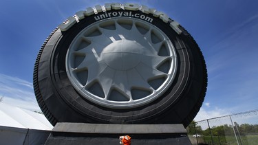 The Uniroyal Tire tiger mascot walks by the Giant Uniroyal Tire in Allen Park, Mich., Wednesday, May 20, 2015. The 80-foot-high, 12-ton tire is turning 50 and has stood alongside Interstate 94, near Detroit, since 1965, a year after it debuted at the New York World’s Fair.