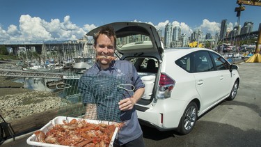 Four Seasons Vancouver Head Chef Ned Bell with fresh spot prawns and his 2015 Toyota Prius V at False Creek Fisherman's Wharf in Vancouver.