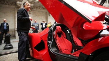 Sergio Marchionne, CEO of Fiat Chrysler Automobiles, is viewed next to a Ferrari after ringing the Closing Bell on the floor of the New York Stock Exchange (NYSE) on October 13, 2014 in New York City. As chances of a merger deal with GM fade, FCA is reportedly considering deals with other automakers.