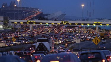 Commuters wait in standstill traffic to pay their tolls on the San Francisco-Oakland Bay Bridge in Oakland, Calif. Tolls on heavily crowded roads are being considered in Canada.