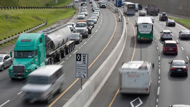 Vehicles zoom along the nearly empty Pan Am Games HOV lanes as morning rush hour traffic crawls along in Toronto on Monday June 29, 2015.