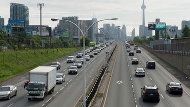 Vehicles crawl past the nearly empty Pan Am high-occupancy vehicle lanes as morning rush hour traffic crawls in Toronto on Monday, June 29, 2015.
