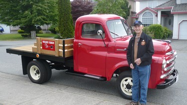 John Welsh alongside his restored 1949 Fargo truck his friends helped him complete.