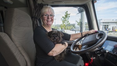 Marijke Brouwer, shown with her dog Buddy, started her career as a big-rig driver in the 1970s before quitting and spending the next 30 years as a wife and mother. She got back behind the wheel about five years ago as a company driver.