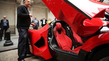 Sergio Marchionne, CEO of Fiat-Chrysler Automobiles, stands next to a LaFerrari after ringing the Closing Bell on the floor of the New York Stock Exchange (NYSE) on October 13, 2014 in New York City. He is Ferrari's new CEO, replacing Amedeo Felisa.