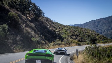 Supercars race through the hills of Monterey.