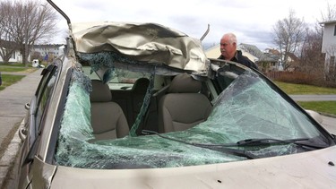 Crash victim Michelle Higgins' car is seen May 23, 2012, at the local bodyshop in Gander, Newfoundland, following a visit to the crash site where she hit a moose. Doctors told Higgins she went into shock, explaining why she continued to drive to work oblivious of the damage.