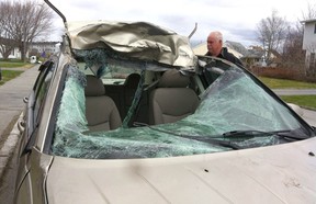 Crash victim Michelle Higgins' car is seen May 23, 2012, at the local bodyshop in Gander, Newfoundland, following a visit to the crash site where she hit a moose. Doctors told Higgins she went into shock, explaining why she continued to drive to work oblivious of the damage.