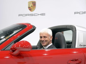 Porsche CEO Matthias Mueller poses in a 911 Targa 4 GTS during the company's annual press conference at the Porsche museum in Stuttgart, Germany, on March 13, 2015. Rumours suggest he will replace Martin Winterkorn as Volkswagen CEO this week.