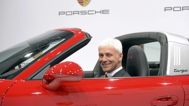 Porsche CEO Matthias Mueller poses in a 911 Targa 4 GTS during the company's annual press conference at the Porsche museum in Stuttgart, Germany, on March 13, 2015. Rumours suggest he will replace Martin Winterkorn as Volkswagen CEO this week.