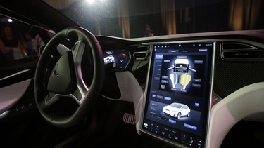 The dashboard of the Tesla Model X is shown at the company's headquarters Tuesday, Sept. 29, 2015, in Fremont, Calif. CEO Elon Musk said the Model X sets a new bar for automotive engineering, with unique features like rear 'Falcon Wing' doors, which open upward, and a driver's door that opens on approach and closes itself when the driver is inside.