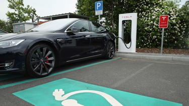 A Tesla electric-powered sedan stands at a Tesla charging station at a highway rest-stop along the A7 highway on June 11, 2015 near Rieden, Germany.