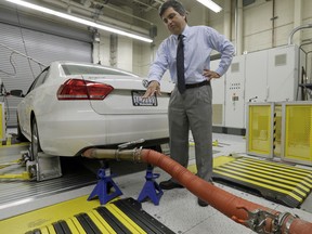 In this Sept. 30, 2015, photo, John Swanton, spokesman with the California Air Resources Board, explains how a 2013 Volkswagen Passat with a diesel engine is evaluated at the emissions test lab in El Monte, Calif.