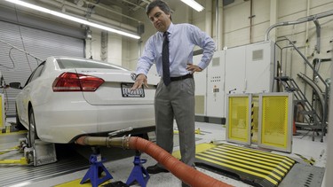 In this Sept. 30, 2015, photo, John Swanton, spokesman with the California Air Resources Board, explains how a 2013 Volkswagen Passat with a diesel engine is evaluated at the emissions test lab in El Monte, Calif.