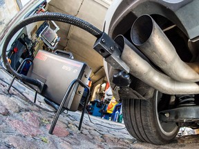 A measuring hose for emissions inspections in diesel engines sticks in the exhaust tube of a Volkswagen Golf 2.0 TDI diesel car at a garage in Frankfurt an der Oder, eastern Germany, on October 1, 2015.