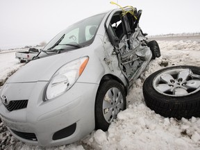 A car lies damaged and abandoned in a ditch off the Trans-Canada Highway east of Calgary, Alberta, Thursday, April 29, 2010 following a late burst of winter.