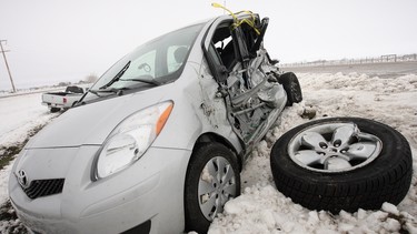 A car lies damaged and abandoned in a ditch off the Trans-Canada Highway east of Calgary, Alberta, Thursday, April 29, 2010 following a late burst of winter.