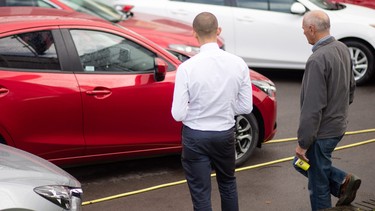 A customer looks at a brand new Mazda car that is offered for sale on the forecourt of a main motor car dealer in Brislington on October 6, 2015 in Bristol, England.