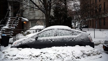 A snow covered car sits along a road on February 18, 2014 in Brooklyn area of New York City. Prepare the right way and winter's bite won't be that harsh.
