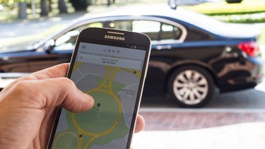 A person uses the UberX app on October 30, 2015 in Canberra, Australia. The city is the first in the world to legalize UberX, allowing people to access and offer ridesharing services without fear of fines or license suspensions.