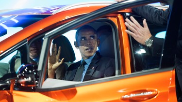 President Obama talks to GM President Dan Ammann, right, while sitting in the 2017 Chevrolet Bolt EV, an all-electric vehicle with an estimated range of 200 miles on a single charge, as he tours the North American International Auto Show in Detroit, Wednesday, Jan. 20, 2016.