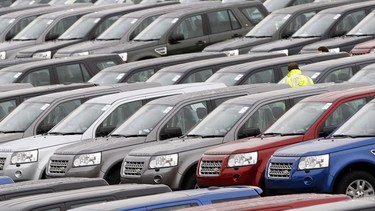 Rows of new Range Rover SUVs sit on a dealership lot in 2015.