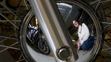 Barb Munro, Heritage Park's public relations director, mugs for a photo with motorcycles arriving at the park's Gasoline Alley 
21, 2016. Vintage motorcycles will be on display for Reflections in Chrome, a show opening on Feb. 4.