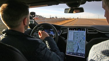 Calgary Herald writer Tom Babin lets the Autopilot drive the Tesla Model S P90D electric car east of Calgary on Thursday, Nov. 12, 2015.