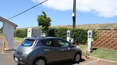 A Nissan Leaf rental car plugged into a JUMPSmart Level 3 fast charge station at the Maui Ocean Centre.