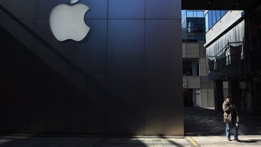 A man walks past an Apple store in Beijing