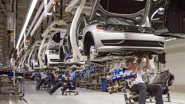 In this July 12, 2013, file photo, employees at the Volkswagen plant in Chattanooga, Tenn., work on the assembly of Passat sedans.