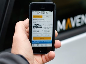 In this Wednesday, April 27, 2016, photo, a smartphone displaying the Maven app, a General Motors car-sharing service, is shown, in Ann Arbor, Mich. Automakers are reinventing themselves as "mobility" companies that can accommodate all the different ways people get around. Already this year, General Motors Co. has announced a long-term alliance with ride-hailing company Lyft and started Maven.