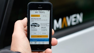 In this Wednesday, April 27, 2016, photo, a smartphone displaying the Maven app, a General Motors car-sharing service, is shown, in Ann Arbor, Mich. Automakers are reinventing themselves as "mobility" companies that can accommodate all the different ways people get around. Already this year, General Motors Co. has announced a long-term alliance with ride-hailing company Lyft and started Maven.