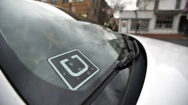 In this photo taken Feb. 25, 2016, an Uber decal is displayed in the their window of the car owned by Steve Linnes, a music teacher in State College, Pa., who is also a part-time Uber driver.