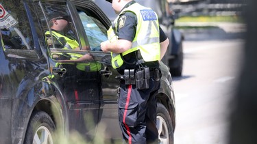 In this file photo, a police officer pulls over a motorist.